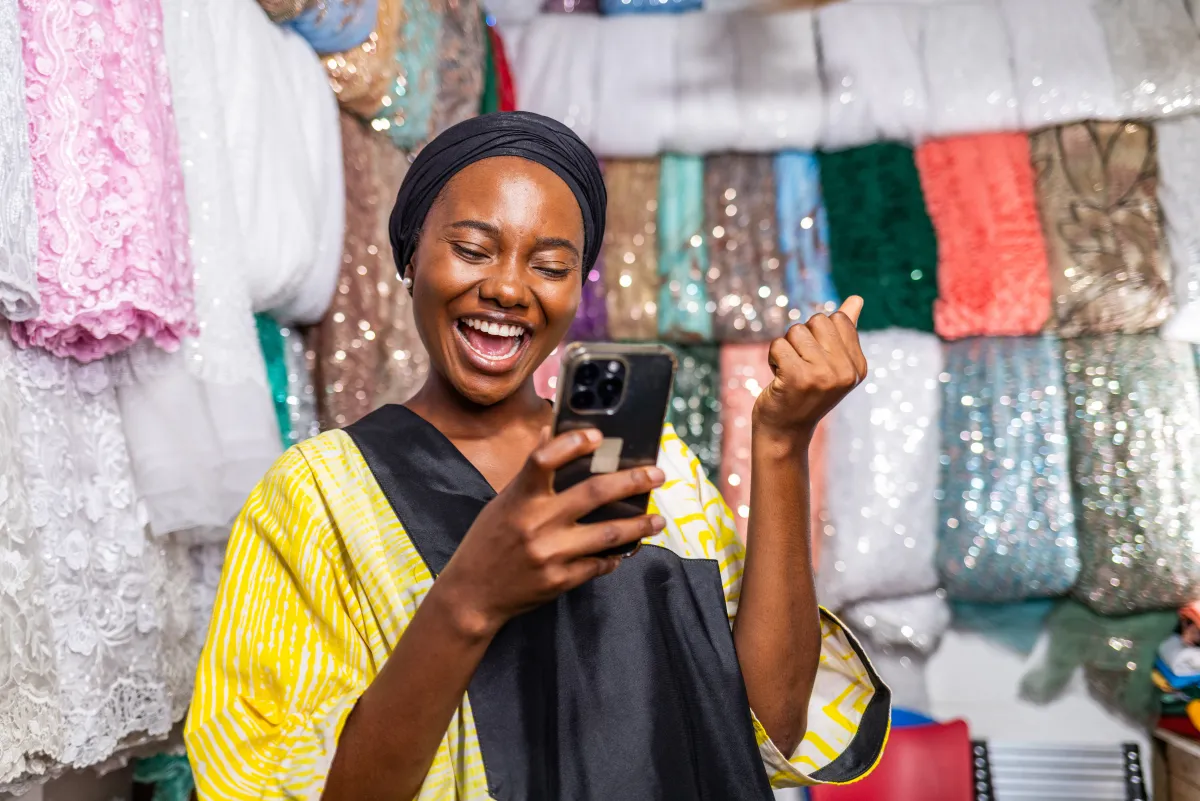 Trader using PesaScope at her market stall